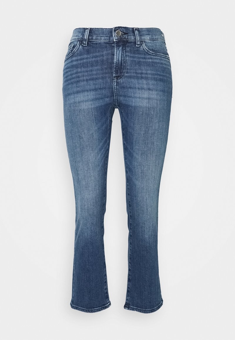 Ljust blå denimjeans med en åtsittande överdel och utsvängda nederdelar. Har en klassisk design med fem fickor och knäppning i midjan.