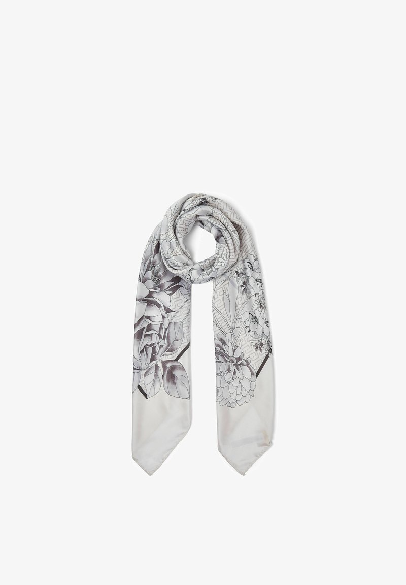 Écharpe en soie gris clair avec des motifs floraux noirs et blancs, nouée lâchement sur un fond blanc.