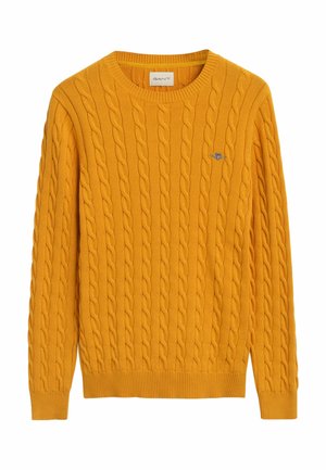 Geel kabelgebreid sweater met een ronde hals, ribbels aan de mouwen en onderkant. Heeft een klein geborduurd logo op de borst. Gemaakt van zacht materiaal.