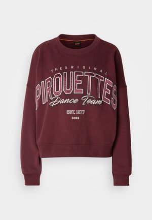 Felpa corta color bordeaux con maniche lunghe. Presenta la scritta "Pirouettes Dance Team" stampata in caratteri bianchi e argentati in grassetto. Texture morbida.