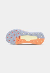Schoenzool met meerkleurig profiel in grijs, oranje en beige, met geometrische patronen en de tekst "NIKE TRAIL" in het midden.