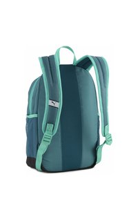 Sac à dos bleu sarcelle et marine avec poches latérales en mesh, bretelles rembourrées et logo distinctif. Tissu texturé pour la durabilité et le confort.