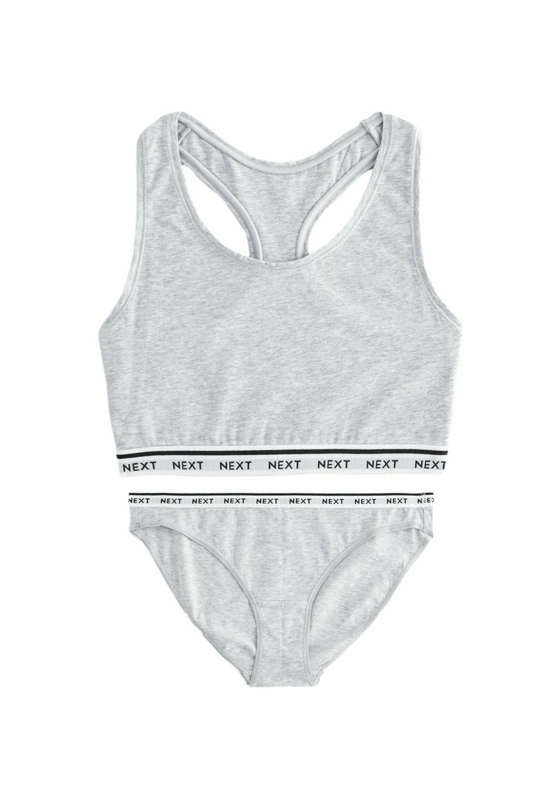Hallide tank top ja aluspüksid pehmest kangast, racerback disainiga ning musta ja valgega korduva "NEXT" brändinguga vöökoht.