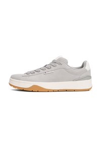 Gray suede sneaker with textured fabric, round laces, rubber sole, and subtle branding. Features a cushioned collar and contrasting gum outsole.