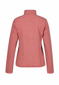 Rosa jacka med hög krage, långa ärmar och en mönstrad textur av små, upprepande, blockliknande former.