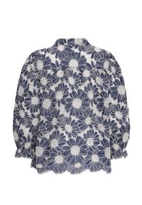 Blouse marine à motifs floraux avec des marguerites blanches, col rond, manches bouffantes à ourlet festonné, confectionnée en tissu léger.