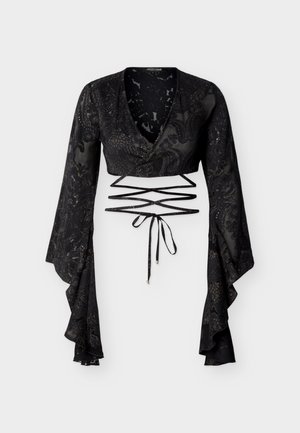 Black sheer crop top with long flared sleeves, wrap front, floral patterns, and crisscross waist ties with gold-tipped ends.