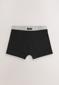 Boxer en coton noir avec une ceinture élastique grise marquée "NEXT." Dispose d'une poche avant et de coutures plates pour le confort.