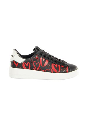 Black low-top sneaker with red heart patterns, black laces, white heel tab with logo, and thick white sole.