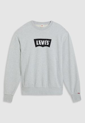 Pelēks krekls ar garām piedurknēm, izgatavots no kokvilnas, ar lielu melnu Levi's logo uz krūšu daļas. Tam ir apaļa kakla izgriezums un ribināti piedurkņu gali.