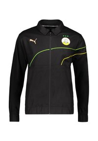 Schwarze Zip-Jacke mit Kragen, die ein gelb-grünes Design aufweist, Puma-Logo in Gold und ein grafisches Emblem auf der Brust.