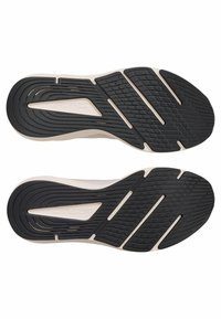 Zwarte rubberen zool met groeven en witte accenten, met een gestroomlijnde vorm en een gestructureerd patroon voor grip. Merkl logo zichtbaar.