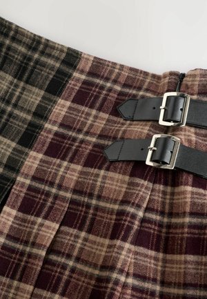 Kilt-stiilis seelik, mis on valmistatud ruudulisest kangast, sisaldades musta, beeži ja burgundia toone. Kaasas on kaks musta nahast rihma hõbedaste pandlatega.