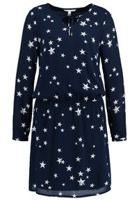 Mörkblå långärmad klänning med vitt stjärnmönster, elastisk midja och liten knytdetalj vid den runda halsringningen.
