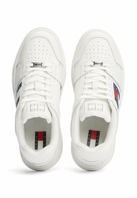 Sneakers bianchi in pelle con punte perforate, design con lacci, strisce laterali blu e rosse e etichetta con logo sulla linguetta. Suola in gomma piatta.