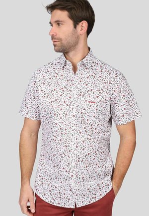 Chemise à manches courtes avec boutons, de couleur blanche, ornée d'un motif floral multicolore. Elle présente un col classique et une poche poitrine avec un logo.