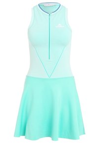 Une robe sans manches en tissu vert clair, dotée d'une fermeture éclair à l'avant, d'accents en maille sur le corsage et d'une jupe évasée.