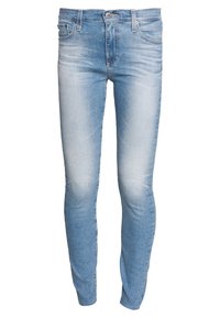 Jeans ajustados de mezclilla de color azul claro con un acabado desgastado, con un cierre de botón y cremallera, cinco bolsillos y detalles de costura sutiles.