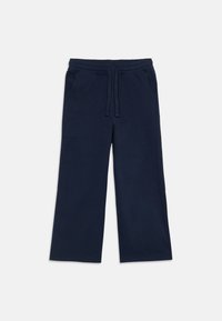 Marineblaue Sweatpants mit lockerem Schnitt, elastischem Bund, Kordelzugverschluss und zwei Seitentaschen. Weiches Baumwollmaterial, glatte Textur.