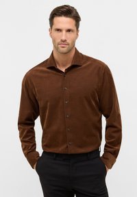 Bruine corduroy button-up shirt met een spread collar en zwarte knopen, lange mouwen en een gladde textuur, gedragen met zwarte broeken.