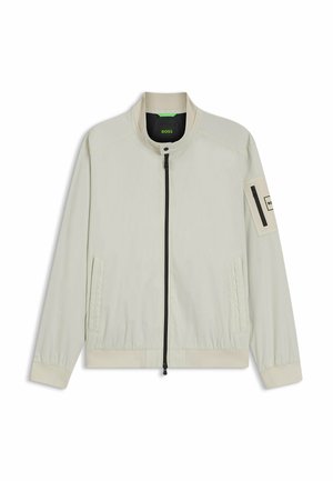 Hellbeige Reißverschlussjacke mit Stehkragen, zwei Fronttaschen, elastischen Bündchen und einer Reißverschlusstasche auf dem linken Ärmel mit der Aufschrift "BOSS".