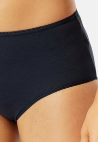 Dark navy cotton brief with a smooth texture, high-cut leg openings, and a delicate scalloped waistband detail. Simple, classic design.