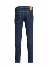 Dark blue slim-fit jeans with two back pockets and a tan leather brand patch on the waistband.