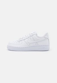 White leather sneaker with a smooth texture. Rounded toe, perforated detailing on the front, and a thick rubber sole. Subtle branding on the side.