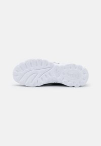 White rubber sneaker sole featuring a textured grip pattern, logo detailing, and a sleek design with ridged accents for traction.