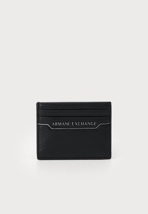 Black leather cardholder with multiple slots, embossed logo, smooth texture, and contrasting silver accents on the front.
