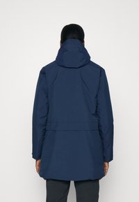 Navy blue waterproof jacket with a hood, featuring a mid-length design, smooth texture, and a belted waist detail.