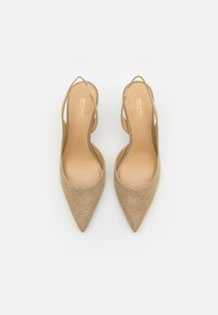 Golden, glittery high-heeled slingback shoes with pointed toes and open sides. Features a smooth, nude insole and thin ankle straps.