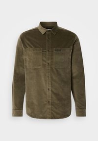 Olive green corduroy shirt with a collar, button-up front, and two chest pockets. Features a subtly branded label on the pocket.