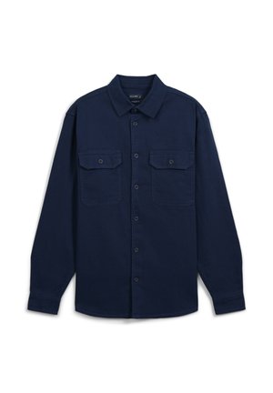 Chemise à manches longues bleu marine en coton, dotée de deux poches poitrine, d'une fermeture à boutons sur le devant et d'un col classique.