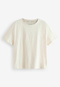 Krämfärgad kortärmad T-shirt i mjuk bomull, med rund halsringning och avslappnad passform. Minimalistisk design utan mönster.