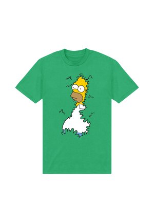 T-shirt in cotone verde con un design di personaggio dei cartoni animati di Homer Simpson nascosto tra i cespugli, indossante una camicia bianca e pantaloni blu.