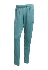 Pantalones deportivos en color verde azulado con cinturilla elástica, bolsillos laterales, piernas ajustadas y un pequeño logo negro en el muslo superior.