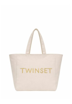 Borsa a mano beige con due manici e la parola "TWINSET" ricamata in filo d'oro al centro frontale.