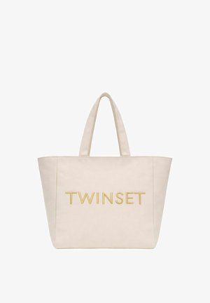 Borsa a mano beige con due manici e la parola "TWINSET" ricamata in filo d'oro al centro frontale.