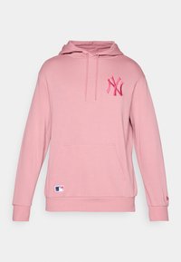 Sweat à capuche rose avec une poche kangourou et des poignets côtelés, arborant un logo NY brodé sur la poitrine et une petite étiquette MLB en bas.