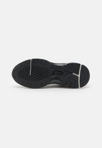 Soletta nera della sneaker in gomma testurizzata, caratterizzata da motivi esagonali e treads pronunciati per una migliore aderenza. Accentata da una soletta intermedia di colore chiaro.
