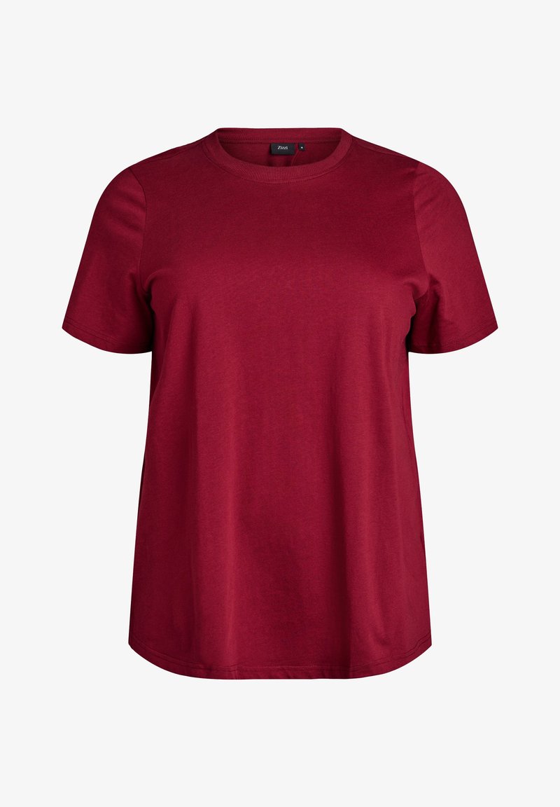 Červené bavlnené tričko s okrúhlym výstrihom a krátkymi rukávmi. Má voľný strih a hladkú textúru. Bez viditeľných vzorov alebo kovania.