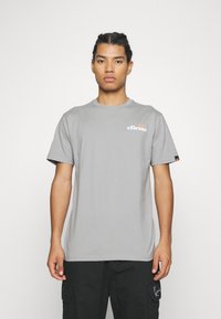 Gray short-sleeve t-shirt with a crew neck, featuring a small colorful logo on the chest and a branded tag on the sleeve. Smooth texture.