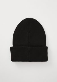 Black knit beanie with a rounded top and a cuffed hem. The texture is ribbed, and the fabric appears soft and elastic.