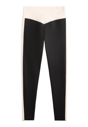 Schwarze und cremefarbene Leggings mit High-Waist-Design, die an der Vorderseite einen diagonalen cremefarbenen Akzent aufweisen und aus glattem, dehnbarem Material bestehen.
