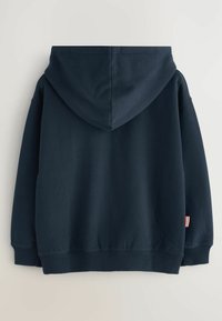 Sudadera con capucha azul marino de corte relajado, con puños y dobladillo acanalados, y un pequeño detalle en rojo y blanco en la manga.