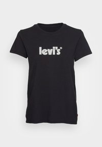 Camiseta de algodón negra con mangas cortas, que presenta un audaz logo en blanco de "levi's®" en la parte delantera. Diseño de cuello redondo, textura suave.