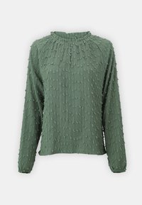 Blouse verte texturée à manches longues avec un col rond et un motif de points en relief sur toute la surface. Tissu doux et léger avec une coupe décontractée.