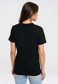 Black short-sleeve T-shirt made of cotton, featuring a simple crew neckline and a relaxed fit, shown from the back against a light background.