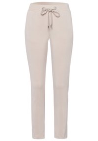 Beżowe spodnie dresowe uszyte z miękkiego materiału, z elastycznym pasem na sznurku, fason slim fit oraz bocznymi kieszeniami.